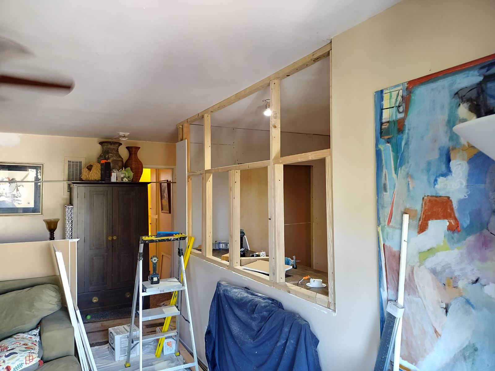 Partition pass-through freshly framed during a Westside living-room remodel